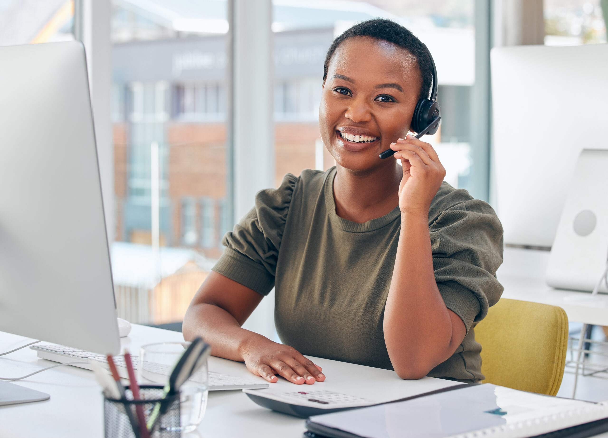 Shot of a woman wearing a headset while working in a call centre.